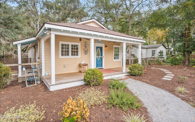 bungalow-style house with ceiling fan and covered porch