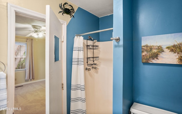 bathroom featuring ceiling fan, a textured ceiling, toilet, and a shower with shower curtain