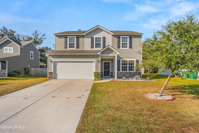 view of front of house with a garage and a front lawn