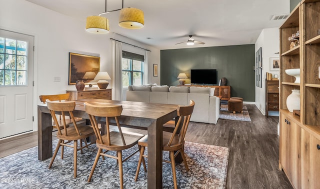 dining space with dark hardwood / wood-style floors and ceiling fan