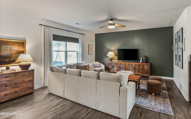 living room with dark wood-type flooring and ceiling fan