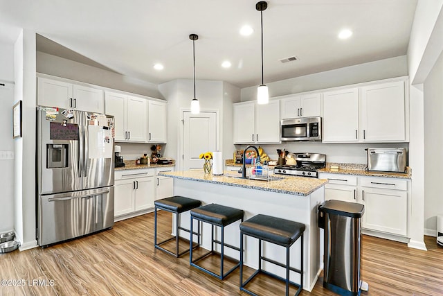 32 Chinquapin St, Beaufort, SC 29906 - kitchen with white cabinets, stainless steel appliances, visible vents, and a sink
