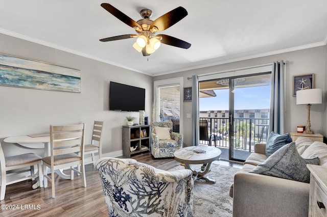 living room featuring crown molding, ceiling fan, and wood-type flooring