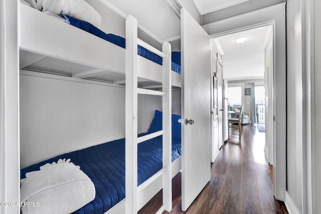 bedroom featuring dark wood-type flooring and crown molding