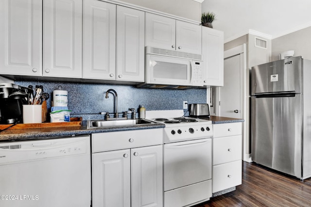 kitchen with sink, white appliances, dark hardwood / wood-style floors, tasteful backsplash, and white cabinets