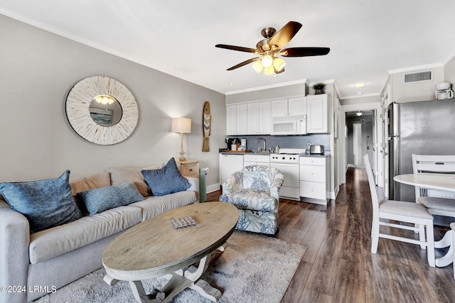 living room with sink, crown molding, dark hardwood / wood-style floors, and ceiling fan