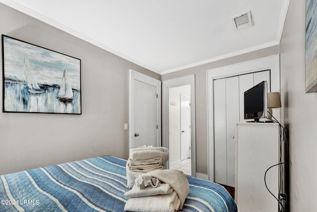 bedroom with crown molding and a closet