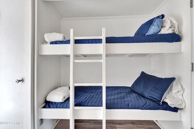 bedroom with crown molding and hardwood / wood-style floors