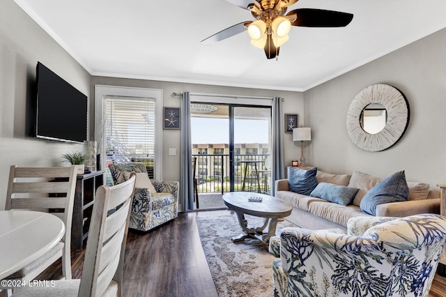 living room featuring crown molding, a healthy amount of sunlight, ceiling fan, and dark hardwood / wood-style flooring