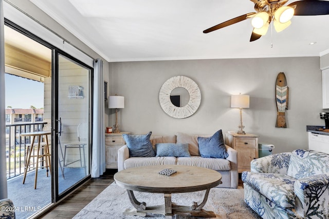 living room with crown molding, dark wood-type flooring, and ceiling fan