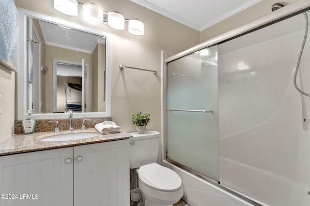 full bathroom featuring vanity, bath / shower combo with glass door, ornamental molding, and toilet