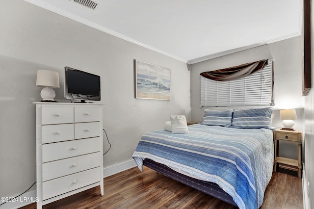 bedroom featuring crown molding and dark hardwood / wood-style floors