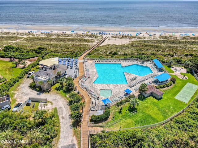 drone / aerial view featuring a water view and a view of the beach