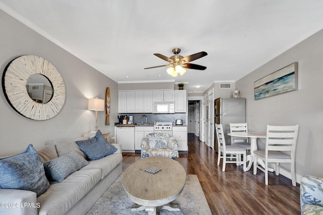 living room with dark hardwood / wood-style flooring, sink, ornamental molding, and ceiling fan