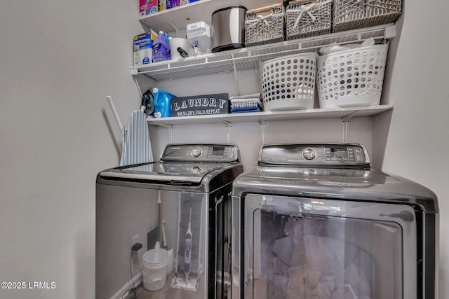 clothes washing area featuring independent washer and dryer