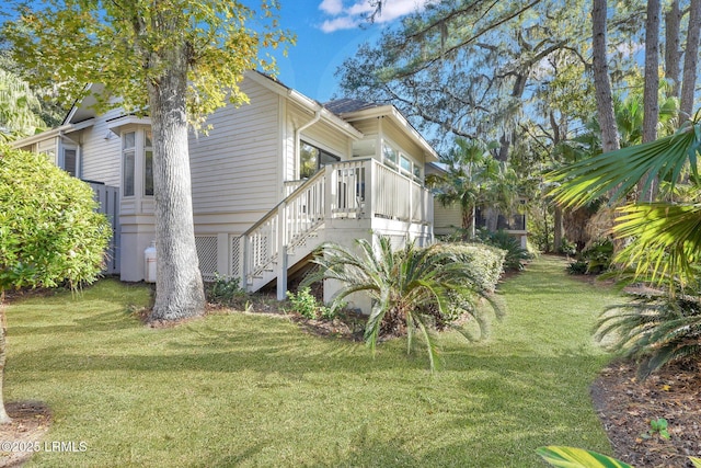 view of side of home featuring a lawn