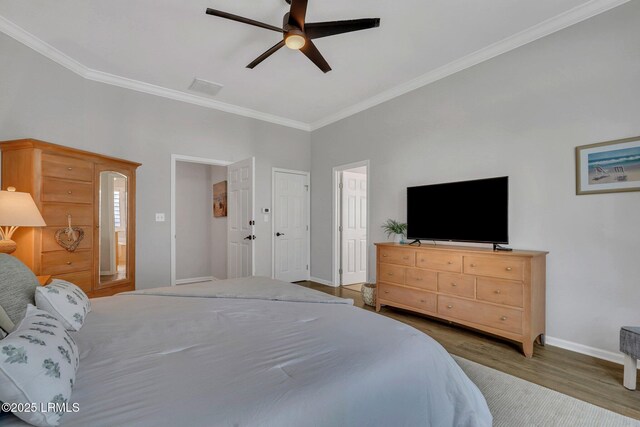 bedroom with wood-type flooring, ornamental molding, and ceiling fan