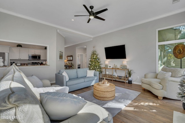 living room featuring crown molding, light hardwood / wood-style flooring, and ceiling fan