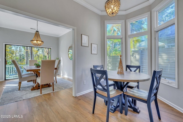 dining area with an inviting chandelier, plenty of natural light, and light hardwood / wood-style floors