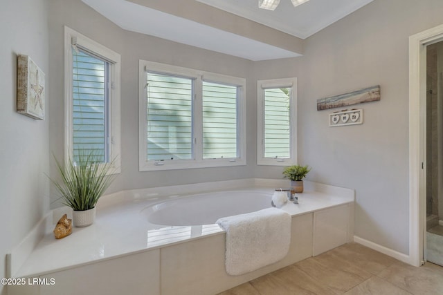 bathroom featuring a bath, crown molding, plenty of natural light, and tile patterned floors