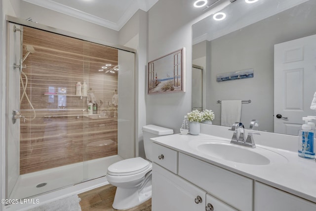 bathroom with toilet, an enclosed shower, ornamental molding, vanity, and hardwood / wood-style floors