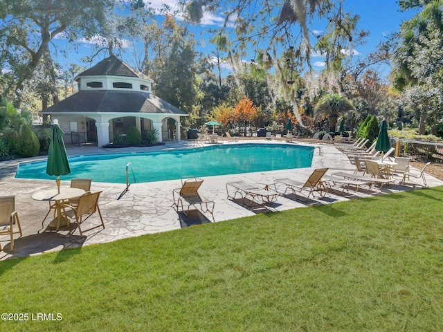 view of pool featuring a yard and a patio area