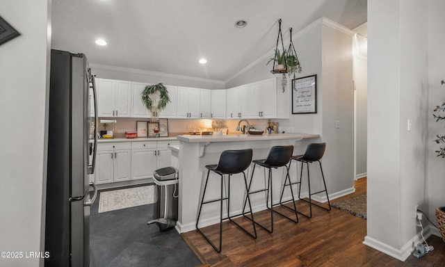 10 Rockville Way, Beaufort, SC 29902 - kitchen featuring freestanding refrigerator, crown molding, a breakfast bar area, white cabinets, and light countertops