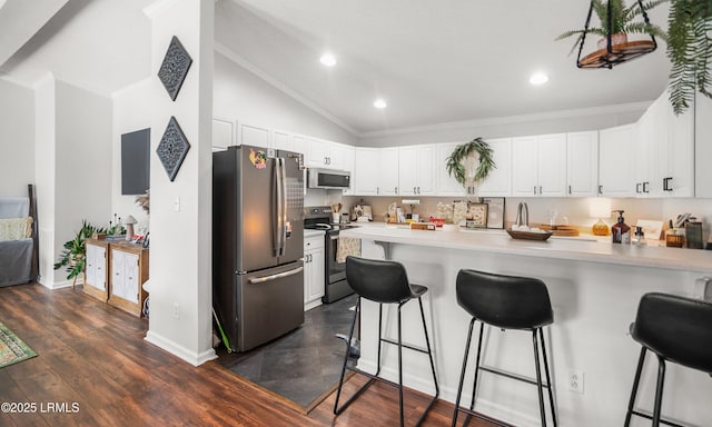 10 Rockville Way, Beaufort, SC 29902 - kitchen featuring stainless steel appliances, lofted ceiling, a breakfast bar area, a peninsula, and white cabinets