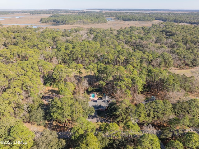 bird's eye view with a wooded view