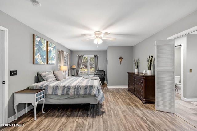 bedroom featuring baseboards, ceiling fan, and light wood-style floors