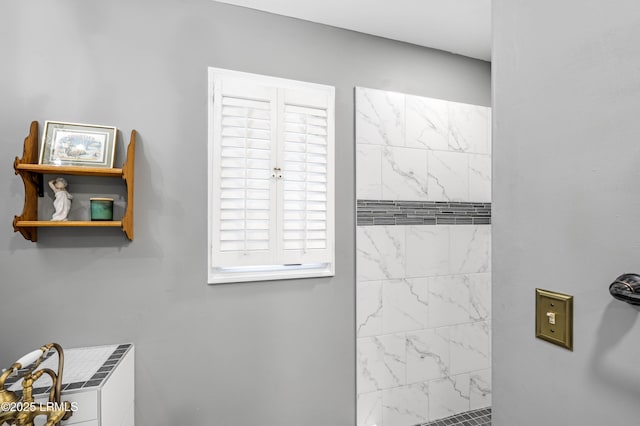 full bath featuring tiled shower