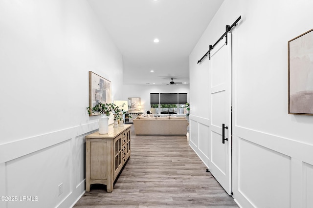 1014 Ferrets End, Beaufort, SC 29902 - hall featuring a barn door, recessed lighting, and light wood-style flooring