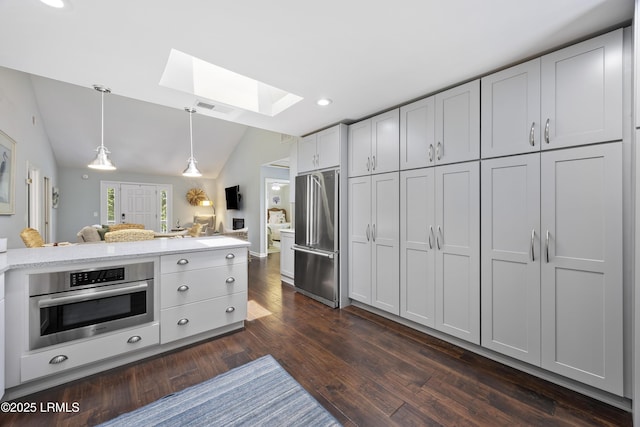 8 Bradley Beach Rd, Hilton Head Island, SC 29928 - kitchen with stainless steel appliances, a skylight, dark wood finished floors, recessed lighting, and vaulted ceiling
