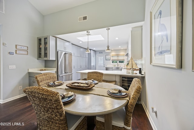 8 Bradley Beach Rd, Hilton Head Island, SC 29928 - dining area with baseboards, dark wood-style floors, a skylight, and recessed lighting