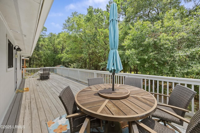 8 Bradley Beach Rd, Hilton Head Island, SC 29928 - wooden terrace featuring outdoor dining area and view of wooded area