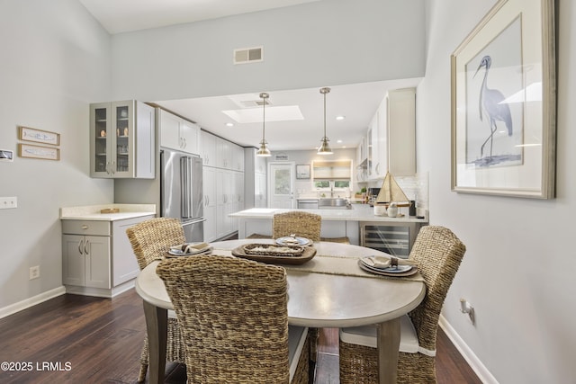 8 Bradley Beach Rd, Hilton Head Island, SC 29928 - dining space with dark wood-type flooring, a skylight, baseboards, and recessed lighting