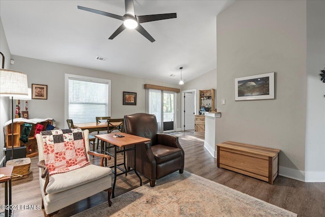 living room featuring lofted ceiling, hardwood / wood-style floors, and ceiling fan