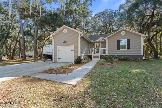 ranch-style home featuring a garage and a front lawn