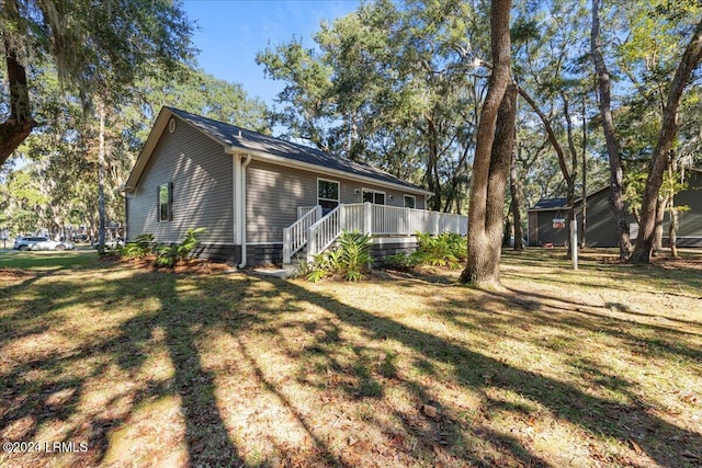 exterior space with a wooden deck and a yard