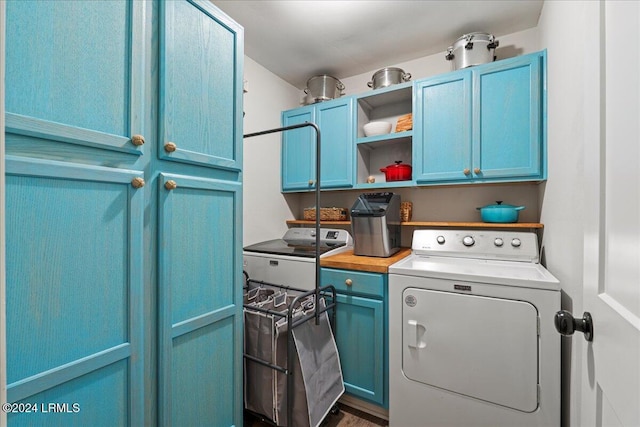 clothes washing area featuring cabinets and washer / dryer