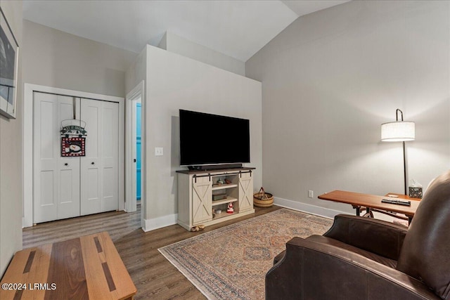 living room with dark hardwood / wood-style floors and vaulted ceiling