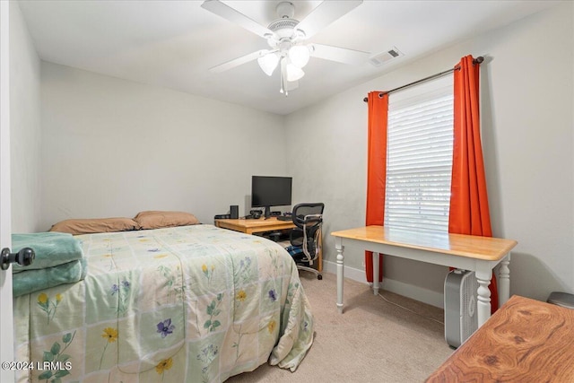 bedroom featuring light colored carpet and ceiling fan