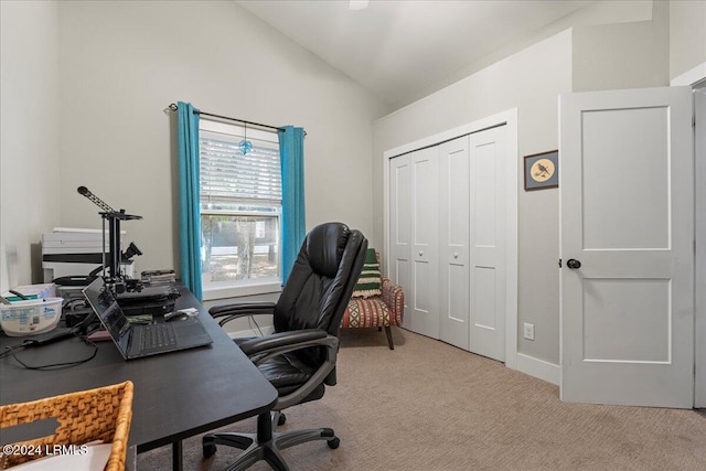 office area featuring vaulted ceiling and light colored carpet