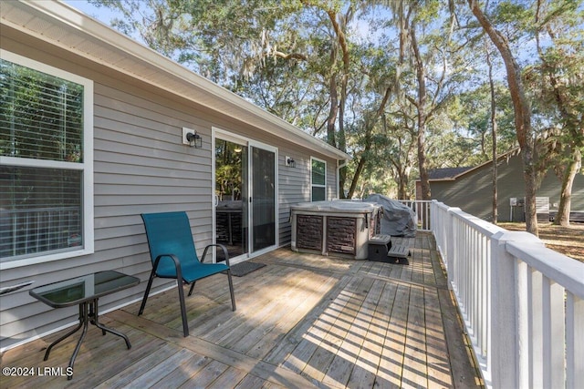 wooden deck featuring a hot tub