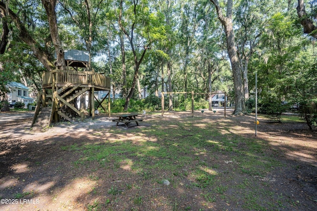 10 Hayek St, Beaufort, SC 29907 - view of yard featuring stairway, view of wooded area, and a wooden deck