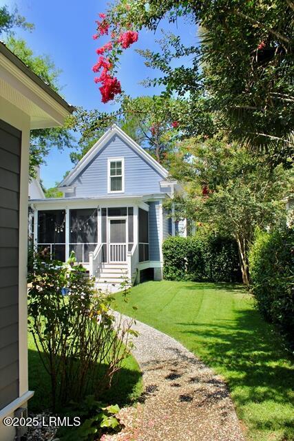 10 Hayek St, Beaufort, SC 29907 - view of front of home with a sunroom and a front lawn