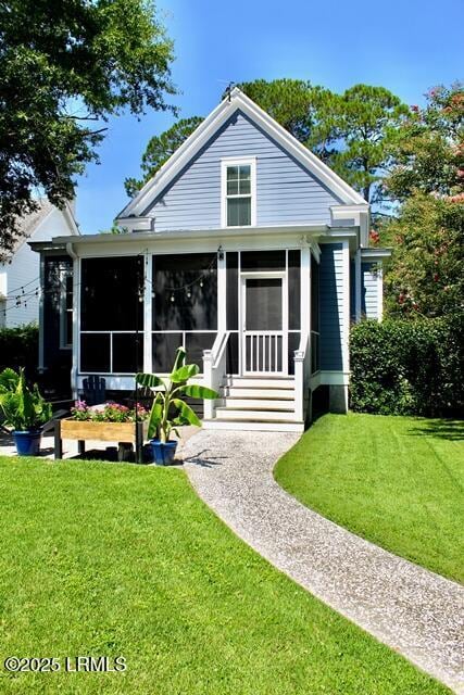 10 Hayek St, Beaufort, SC 29907 - view of front facade with a sunroom and a front yard