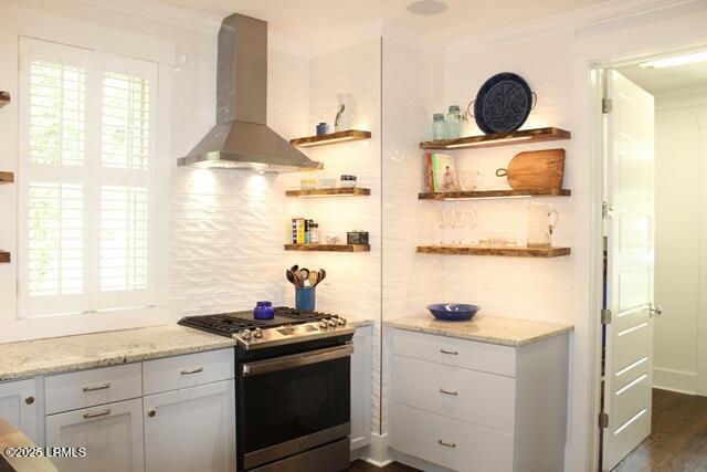 10 Hayek St, Beaufort, SC 29907 - kitchen featuring wall chimney exhaust hood, gas range, open shelves, crown molding, and light stone countertops