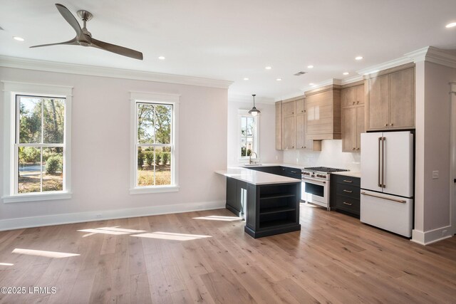 kitchen with pendant lighting, white refrigerator, stainless steel range, ornamental molding, and light brown cabinets