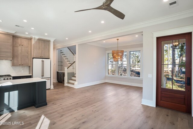 kitchen with light hardwood / wood-style flooring, hanging light fixtures, high end white refrigerator, and ornamental molding